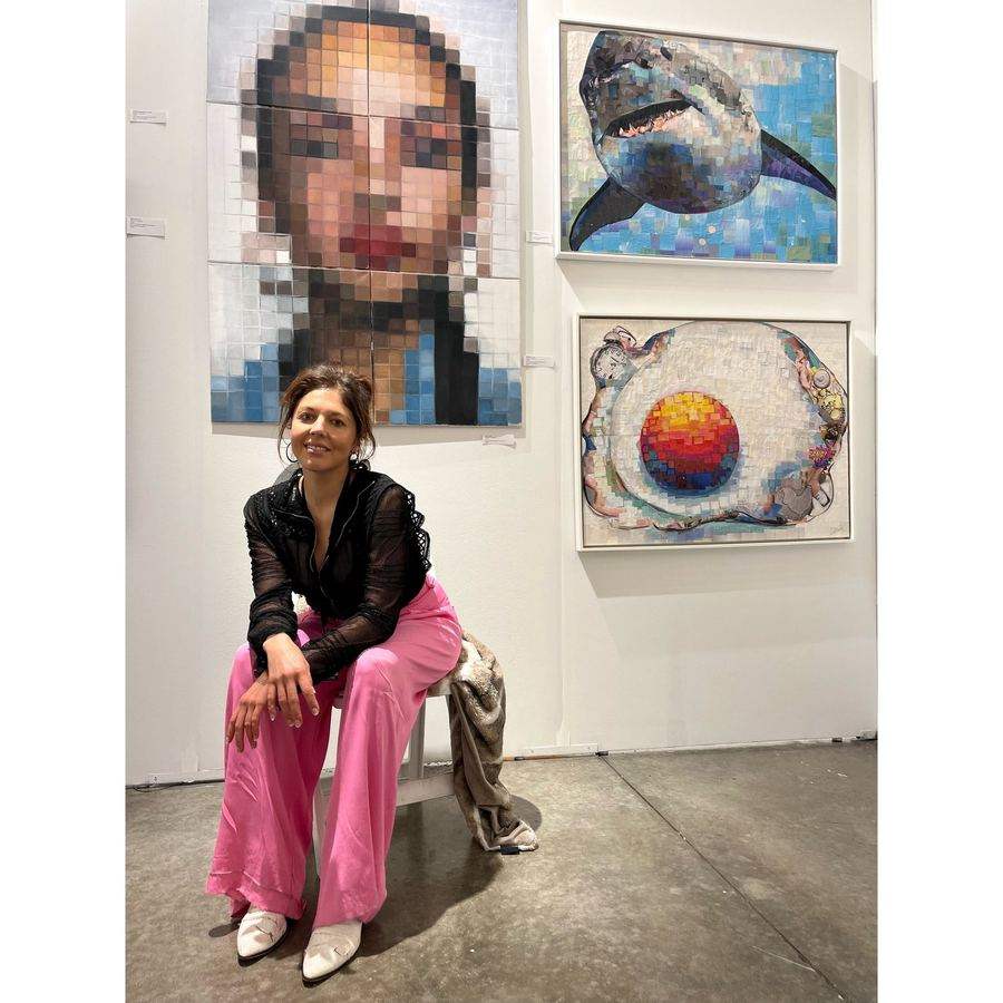 Whitney L Anderson with her collage art at Red Dot Miami during Art Basel week