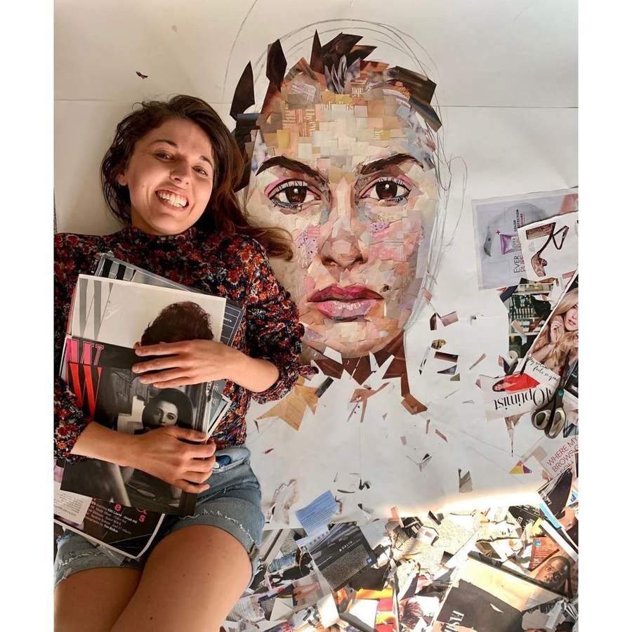 Whitney holding magazines in front of a collage