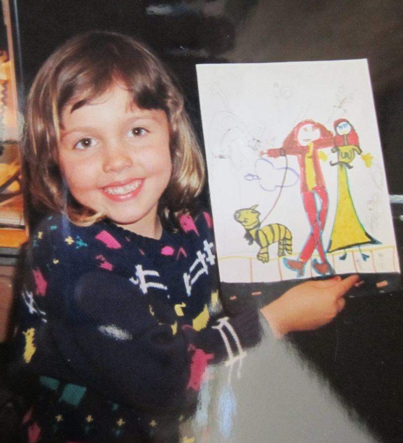 Whitney L Anderson as a little girl holding up one of her first drawings